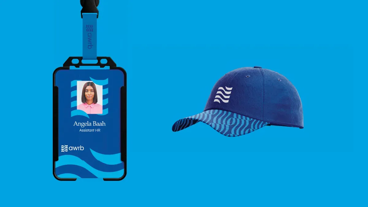 Staff ID badge and a navy cap carrying the wave mark.