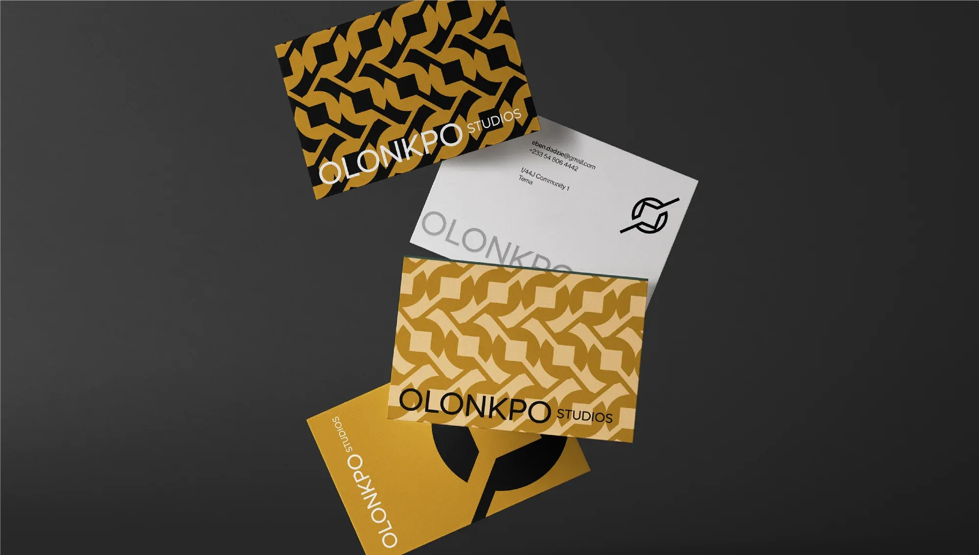 Business cards and a folded patterned cloth, the mark cut through one card as a window.