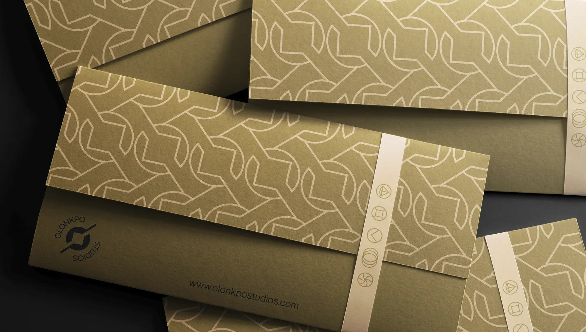 Patterned envelopes fanned across a dark surface, each sealed with a printed band.